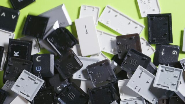Close-up of a collection of keyboard keys from different old laptops on a table