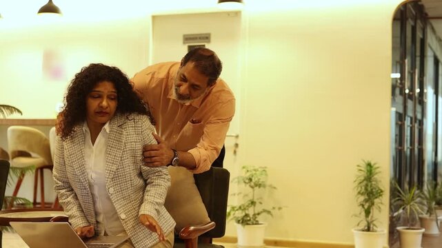 Indian woman being sexually harassed at work. Male Boss touch his female office worker or employee. gender discrimination.and sexual harassment