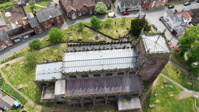 The stunning St Oswald&rsquo;s Church and surrounding Malpas - drone gimbal down and reveal dronie, Cheshire, UK