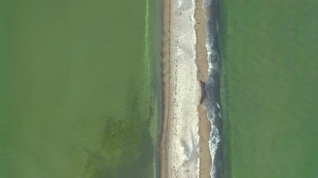 Top-down cinematic footage of Mewia Rewa in Puck Lagoon. Vertical aerial perspective reveals intricate natural patterns of ten-kilometer-long sandbar.