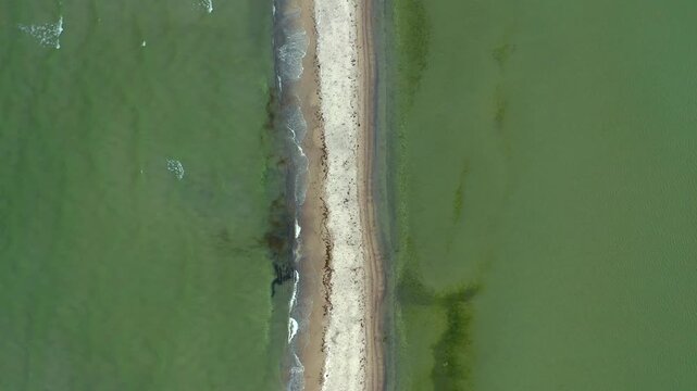 Top-down drone footage of sandbank in Puck Bay. Overhead perspective showcases unique patterns of Rybitwia Mielizna's shallow waters and sandy formations.