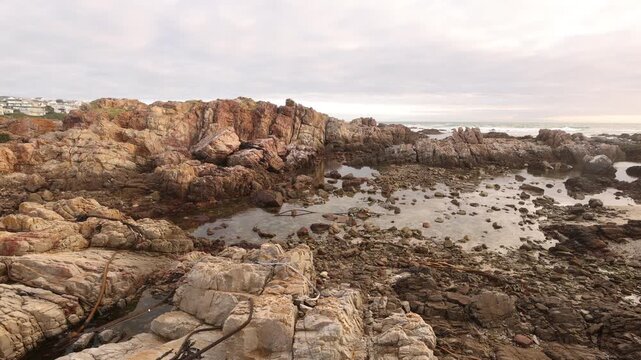 sunset light over rocky coastline of DeKelders, Gansbaai, South Africa