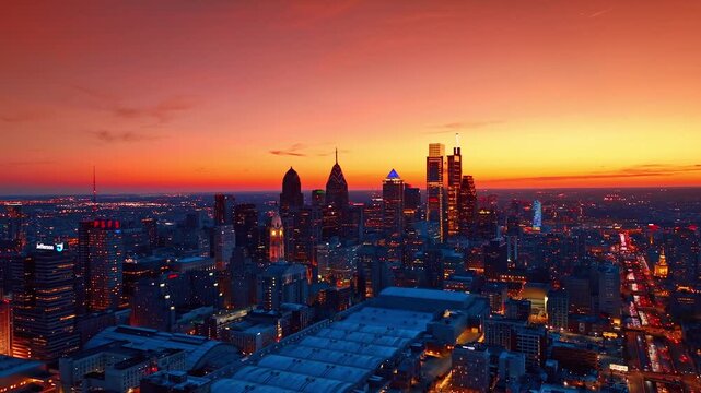 Stunning aerial hyperlapse over philadelphia skyline at sunset, showcasing vibrant city lights and iconic skyscrapers.