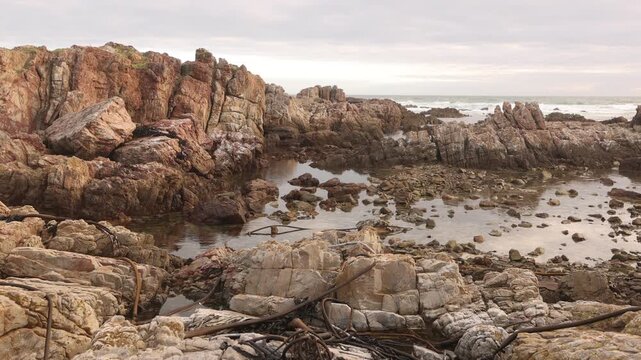 sunset light over rocky coastline of DeKelders, Gansbaai, South Africa