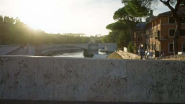 Sunlit riverside bridge in rome soft defocused bokeh background outdoor; background backdrop copyspace calm.