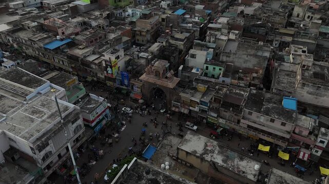 High-angle drone shot of the iconic Holi Gate landmark and busy market streets of Mathura city.