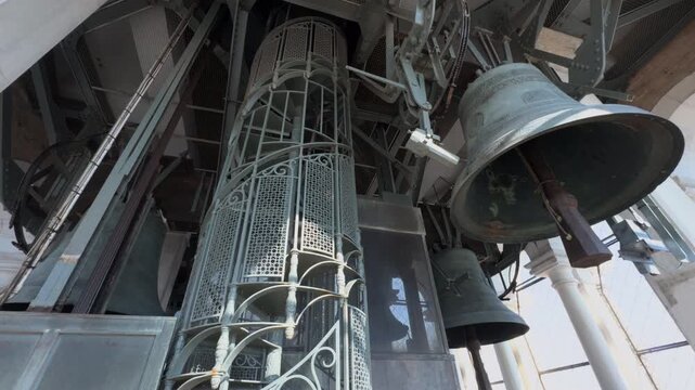 Upward View Inside a Gothic Bell Tower With Hanging Bells