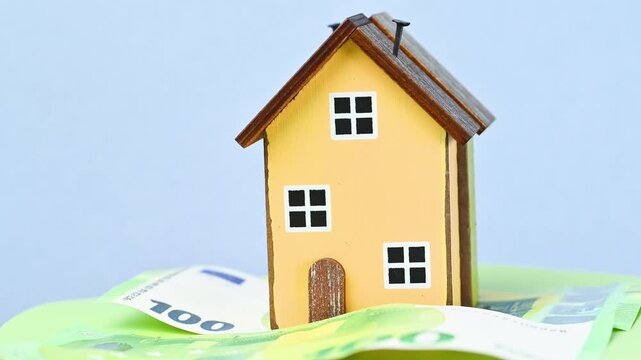 video of a wooden house with euro bills