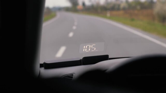 electronic speedometer in a car on the windshield during a trip. speed 100 - 110 km per hour. travel, technology