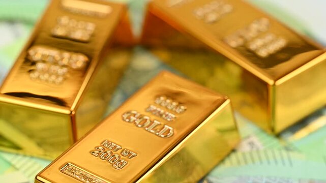gold bars with euro bills