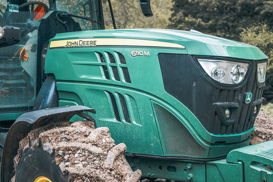 12 October 2025, Valjevo, Serbia: John Deere 6110M tractor showcasing agricultural power with muddy wheel, ready for field work and farming operations