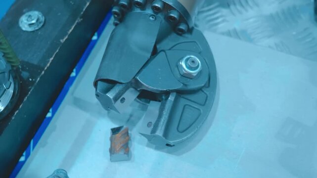 Powerful hydraulic shears capable of easily cutting through thick metal construction rebar are on display at the exhibition. Closeup. Shot in motion