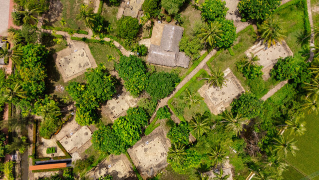 Top-down aerial view of the Son My Memorial grounds, Quang Ngai Province, Vietnam. The overhead perspective shows the layout of the historical relic site with its preserved stone structures, palm-line