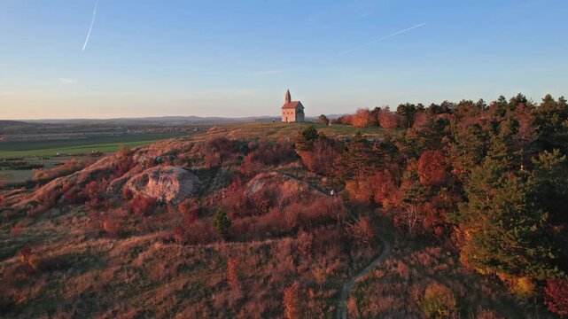 Flying over of Drazovce church (Church of St. Michael the Archangel) at autumn evening, Nitra, Slovakia