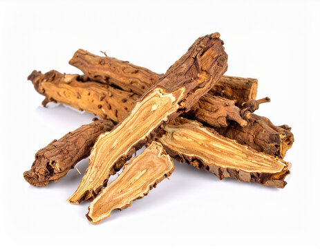 A wooden plate holds a collection of dried Eurycoma longifolia roots, also known as Tongkat Ali or Longjack. These raw, woody segments are isolated against a clean white background, showcasing their n