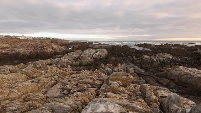 sunset light over rocky coastline of DeKelders, Gansbaai, South Africa