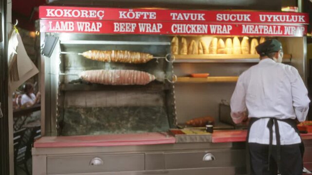 Istanbul street food stall with rotisserie skewers and stacked bread, soft defocused bokeh street; background backplate copyspace calm.