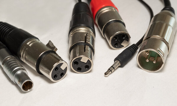 Various short connectors for connecting sound, camera, or video devices to additional equipment. Metal plug, coverd cable, simple connector, three-pin plug, power or signal transmission.