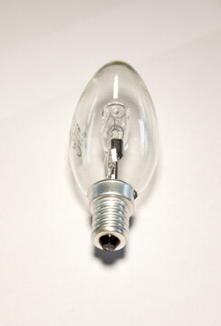 Close-up light bulb. White background, electricity equipment, transparent glass, metal.