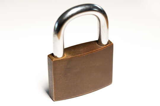 Close-up locked padlock. Safe, security equipment, privacy, metal. White background.