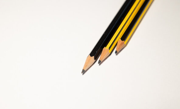 Three different pencils against white background. For drawing pictures and sketches, drawing utensils, for developing creativity.