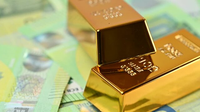 gold bars with euro bills