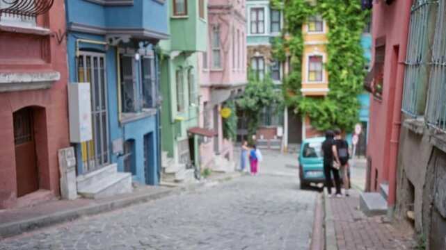 Colorful istanbul cobblestone street with defocused bokeh facades and shallow focus background; background backplate copyspace calm.