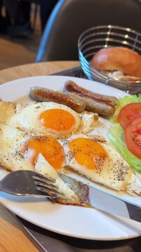 Messy breakfast with fried eggs and sausages