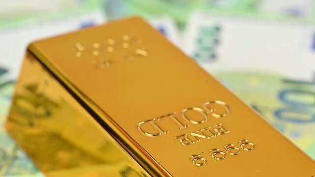 gold bars with euro bills
