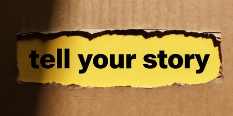 Naklejka premium Text saying tell your story appears on torn yellow paper. Concept for sharing personal tales and business promotion. Focus on communication and connection.