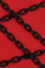 Fototapeta premium Thick black chains overlap on solid red backdrop. Graphic pattern forms diagonal lines, evoking ideas of bondage or industrial strength. Modern abstract design.