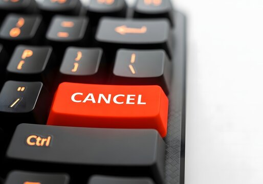 Closeup of a computer keyboard with a red cancel button on white background