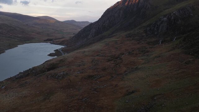 Golden hour light hitting a mountain peak in snowdonia