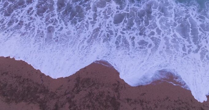 4K video; Aerial view of waves crashing on a beach at the Atlantic coast of Patagonia Argentina