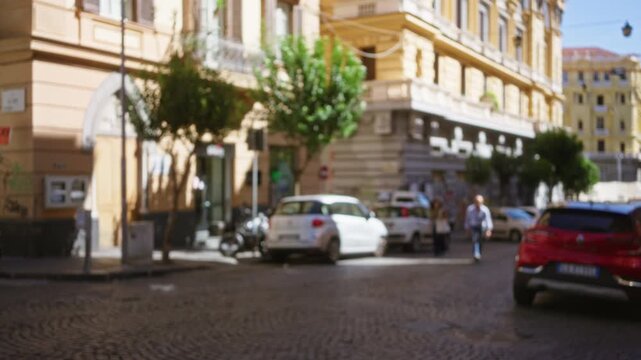 Mediterranean street scene with soft defocused bokeh and shallow focus on sunlit building facades and cobblestone road; background backplate copyspace calm.
