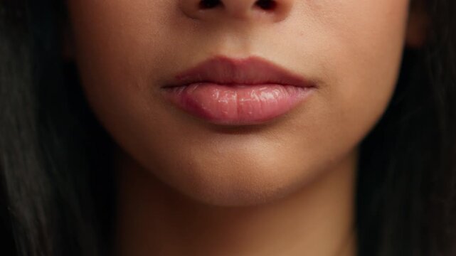 Cropped view close up female mouth sensual lips unrecognizable Hispanic girl unknown woman half face natural moisturize lip balm lipstick perfect skin care beauty filler injection make-up cosmetic