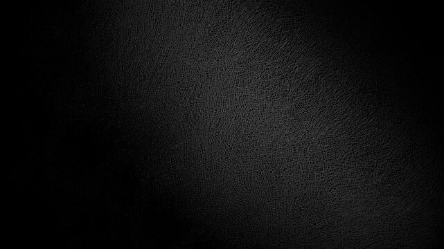 Slow Rotation Over Black Texture. Smooth slow rotation across extreme close-up of fine black pebbled surface with dramatic side lighting.