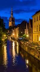 Obraz premium Nighttime cityscape with canal and church.