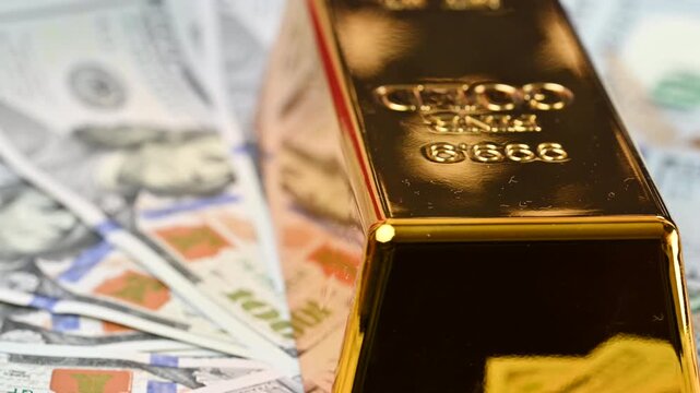 gold bars with dollar bills