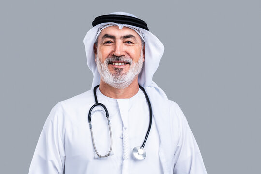 Smiling senior arab male doctor wearing traditional kandora