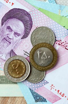 Iranian rial money bills and coins on table. Iran cash of IRR currency close up