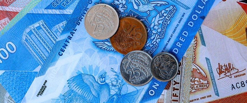 Trinidad and Tobago dollar money bills and coins on table. Trinidad and Tobago cash of TTD currency