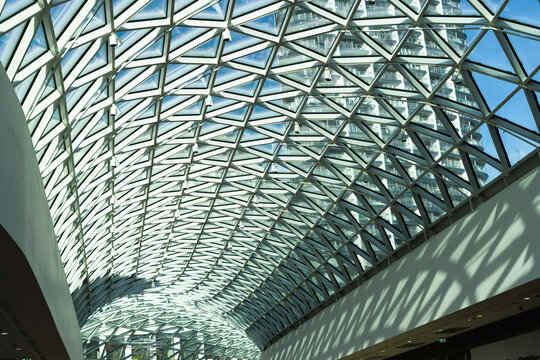 View of the modern curved glass and steel skylight roof of a building with geometric patterns and shadows in Bratislava, Bratislava Region, Slovakia.