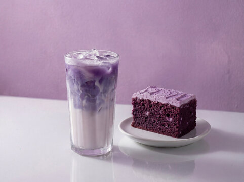 Iced ube latte with purple cake dessert in minimalist coffee shop setting, trendy cafe menu concept featuring indulgent sweet pairing, vibrant purple beverage made from purple yam with creamy texture.