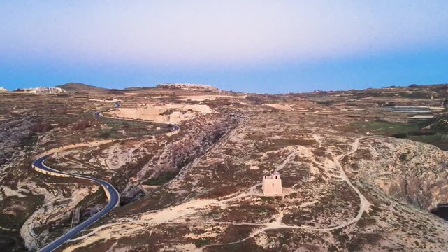 Exploring a Remote Area With Winding Roads and a Historic Tower in Malta During Sunset. Gozo, Malta