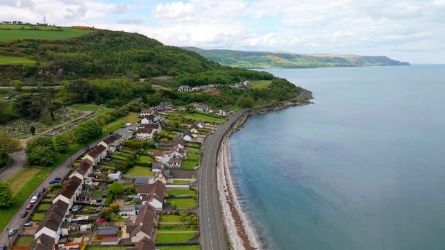 Wide advancing 4K 60FPS aerial video of Glenarm coastal road in County Antrim, Northern Ireland in the UK. Produced in 3840x2160 and with Rec709 color.