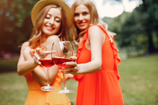 Elegant and stylish girls in a summer park