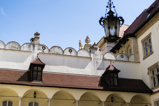 View of the historic courtyard of the Old Town Hall with arched walkways, red-tiled roofs, and ornate architectural details in Bratislava, Bratislava Region, Slovakia.