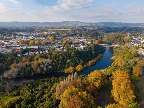 Cambridge, a picturesque town in New Zealand's Waikato region. An aerial view of the town and the Waikato River in autumn