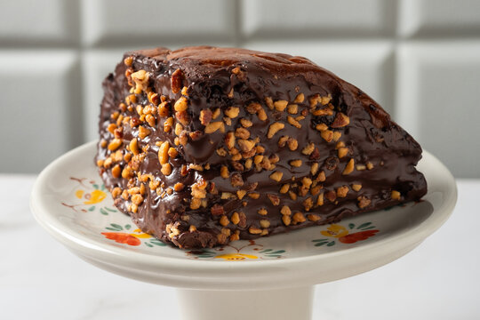 Chocolate fudge cake topped with crushed hazelnuts